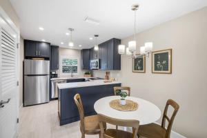 a kitchen and dining room with a table and chairs at Seashells #42 in Ybel