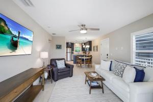 a living room with a couch and a table at Seashells #42 in Ybel +16 photos