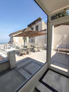 a view of a patio from the window of a house at Le Nouveau Grand Tour - Dimora del Commendatore in San Giorgio Morgeto