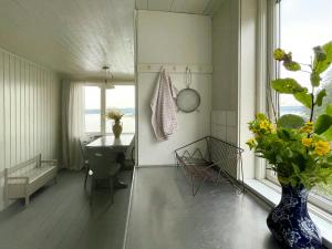 a bathroom with a sink and a vase with flowers at Romantic Summer House On Orust in Stillingsön