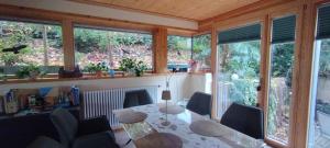 a dining room with a table and chairs and windows at Nichtraucherferienwohnung-Neckarblick ZE-2022-74-WZ-118A in Heidelberg