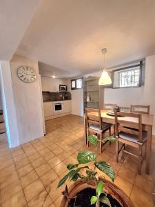 a kitchen and dining room with a table and chairs at Casa medieval Cal Moliner in Omells de Nagaya
