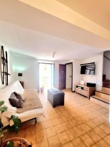 a large living room with a bed and a tv at Casa medieval Cal Moliner in Omells de Nagaya