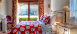 ein Schlafzimmer mit einem Bett und einem großen Fenster in der Unterkunft La Ermita de los Llanos in Arenas de San Pedro + 59 Fotos