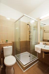 a bathroom with a shower and a toilet and a sink at Partvilla Balatonboglar in Balatonboglár