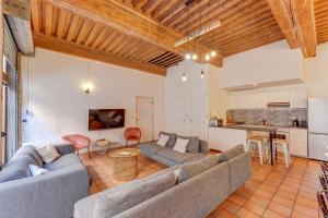 a living room with two couches and a kitchen at NOCNOC - Le Canut in Lyon