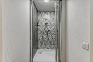 a shower with a glass door in a bathroom at NOCNOC - Le Canut in Lyon
