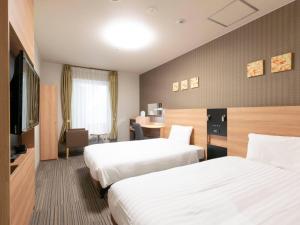 Postel nebo postele na pokoji v ubytování Comfort Hotel Osaka Shinsaibashi