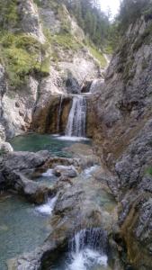 a waterfall on the side of a rocky mountain at Haus Hämmerle in Reutte