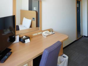a desk with a computer and a mirror at Comfort Hotel Gifu in Gifu