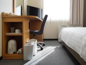 a bedroom with a bed and a desk and a chair at Comfort Hotel Gifu in Gifu +30 photos