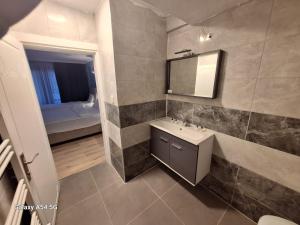 a bathroom with a sink and a mirror at Dilmac Hotel in Gelibolu +110 photos