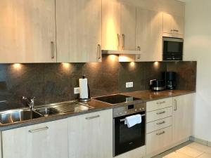 a kitchen with a sink and a stove top oven at Traumwohnung Probst_Lueders Allee in Glücksburg