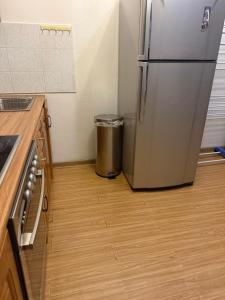 eine Küche mit Kühlschrank und Mülleimer in der Unterkunft Enereltsogtsolbor in Ulaanbaatar