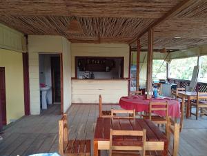 a patio with a table and chairs on a deck at Pensão restauração horizonte in São João