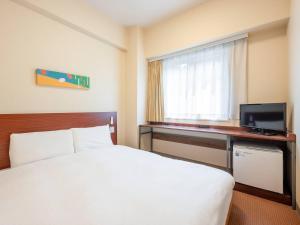 Postel nebo postele na pokoji v ubytování Comfort Inn Fukui