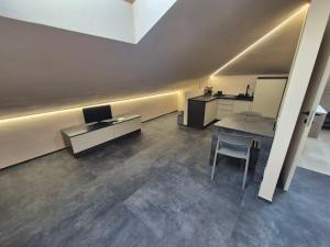 an office with a desk and a table and a chair at Moderna Mansarda con parcheggio gratuito in Diano dʼAlba