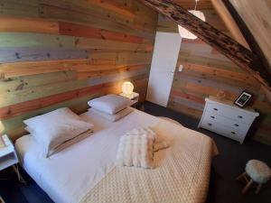 a bedroom with a bed in a wooden wall at Amtawa - Bien-être et Ressourcement in Kirchberg +11 photos