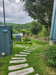 a path with grass and stones in a field at the cabin hulk เขาใหญ่ in Ban Nong Song Hong