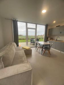 a living room with a couch and a table at AgroReset CAŁOROCZNY in Korlino