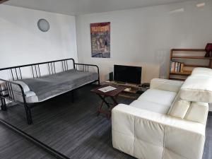 a living room with two beds and a couch at Beaugency-3 sur la route des châteaux in Beaugency