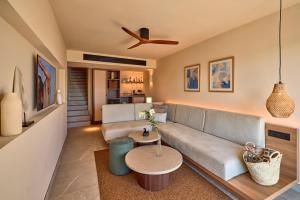 a living room with a couch and a table at Purobeach Resort Santa Ponsa - New Opening in Santa Ponsa