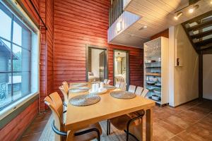 a wooden dining room with a table and chairs at Levillas Karhunvartija 9 in Levi