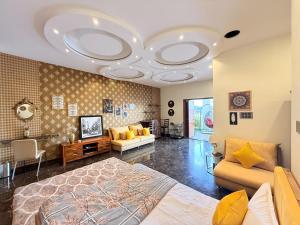 a bedroom with a bed and a living room at Modern Mirage 4BHK Stunning Luxury Spacez Villa in Bengaluru +43 photos