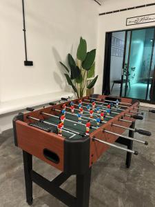 a foosball table with darts on it in a room at Zar House With Swimming Pool in Malacca