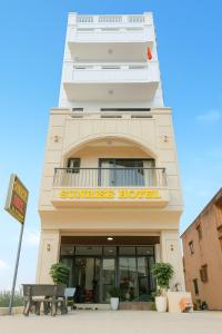 a building with a sunset hotel sign on it at Sunrise Hotel Thiên Cầm in Ha Tinh