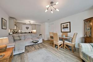 a living room with a couch and a table at Finest Retreats - Riverside View in Balloch +11 photos