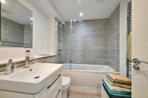 a bathroom with a sink and a tub and a toilet at Finest Retreats - Riverside View in Balloch