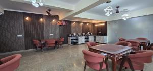 a restaurant with tables and chairs and a counter at Hotel Fortune Home Residency Sector 72 in Noida +25 photos