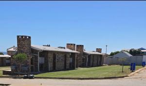 a row of brick buildings on a street at Malkop Sea View Resort in Lambertʼs Bay