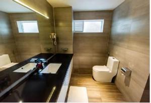 a bathroom with a sink and a toilet at New Mazarine Surf in Nilwella