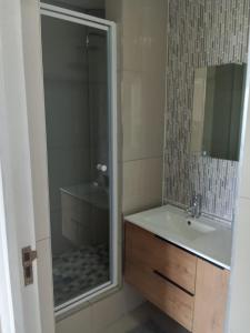a bathroom with a shower and a sink and a shower at Summerstrand, 9th Avenue, Unit 303 Cascades in Port Elizabeth