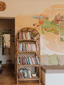 a book shelf filled with books next to a bed at Thikana by Mulaqat in Siliguri