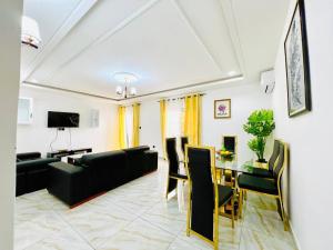 a living room with a couch and a table at Larissa appartement in Yaoundé