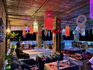 a room with couches and chandeliers in it at Hotel Prem Villas Pushkar in Pushkar