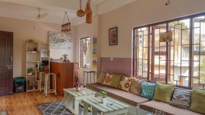 a living room with a couch and a table at Thikana by Mulaqat in Siliguri