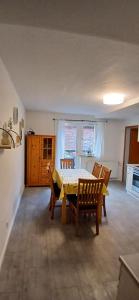 a kitchen with a table and chairs in a room at Ferienwohnung Alte Scheune in Westerburg