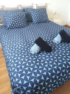 a bed with blue and white sheets and pillows at Dreams Paradise Puerto Rico in Puerto Rico de Gran Canaria