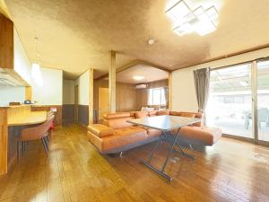 a living room with a couch and a table at 糸島リトリートヴィラ芥屋 in Itoshima