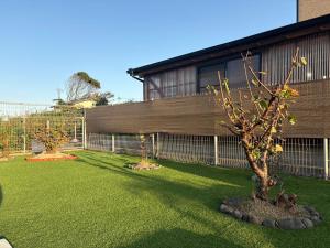 two trees in a yard in front of a building at 糸島リトリートヴィラ芥屋 in Itoshima