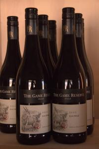 a group of bottles of wine sitting on a shelf at Grünau Chalets in Khomas Region +18 photos