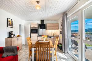 a dining room and kitchen with a table and chairs at Café Pension Pfaus Heidburg in Mühlenbach