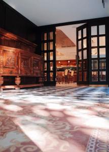 an empty room with a large wooden table in a building at Meriton M Hotel The interior features a terrace offers laundry services Free coffee travel services and dining recommendations It is close to Sanlitun, a vibrant area for young people, and near the subway station, making it convenient to reach any attra in Beijing