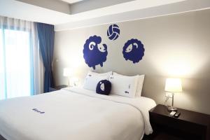 a bedroom with a bed with blue sheep stickers on the wall at Kokotel Phuket Patong in Patong Beach