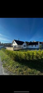 a large white house on the side of a road at Nytt hus i fredfullt nabolag in Verdal
