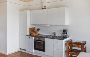 a kitchen with white cabinets and a sink at 5 Bedroom Amazing Home In Hanstholm in Pugdal